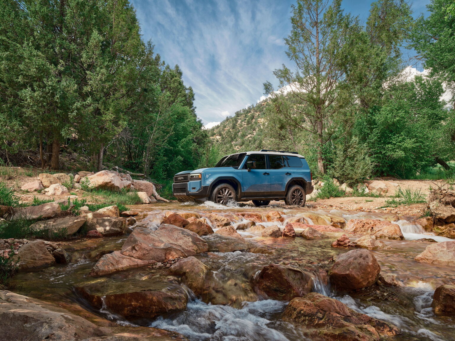 2026 Toyota Land Cruiser parked on rock ledge with canyon view